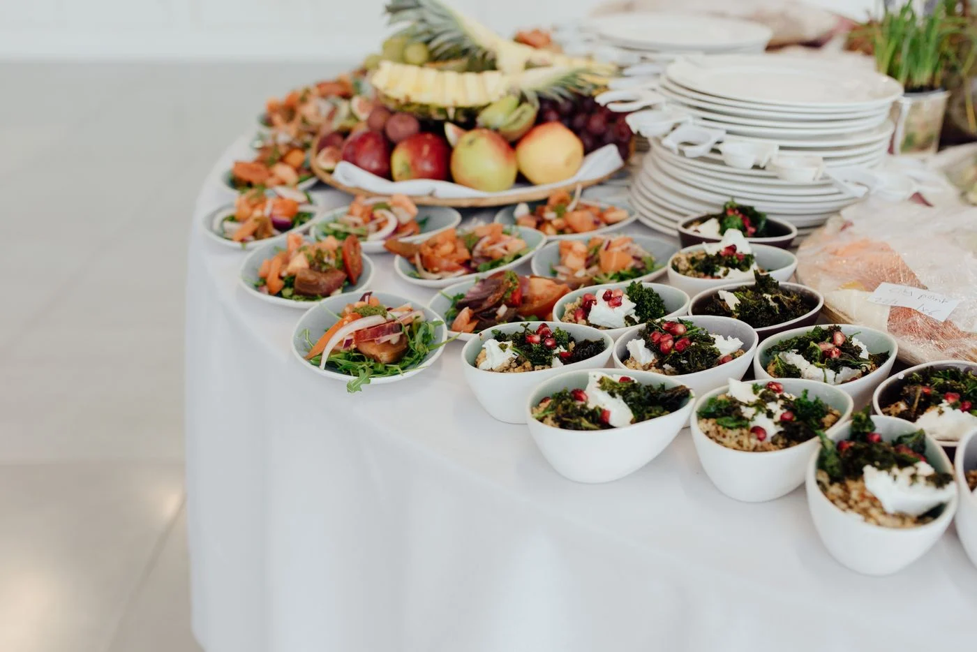 Fresh salads, fruit and dishes arranged for a catered occasion